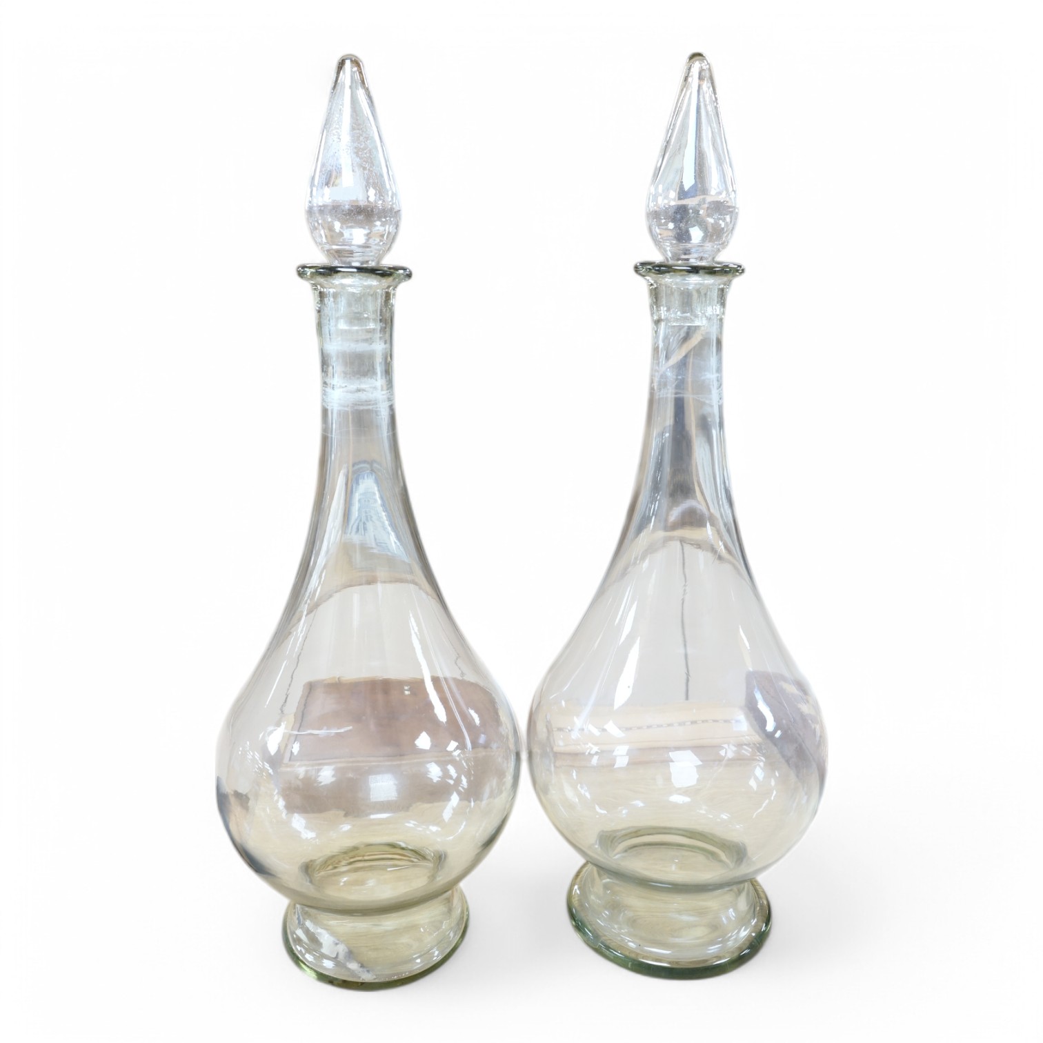 A pair of clear glass chemist's carboys and stoppers, 81cm high including stoppers. Condition - good